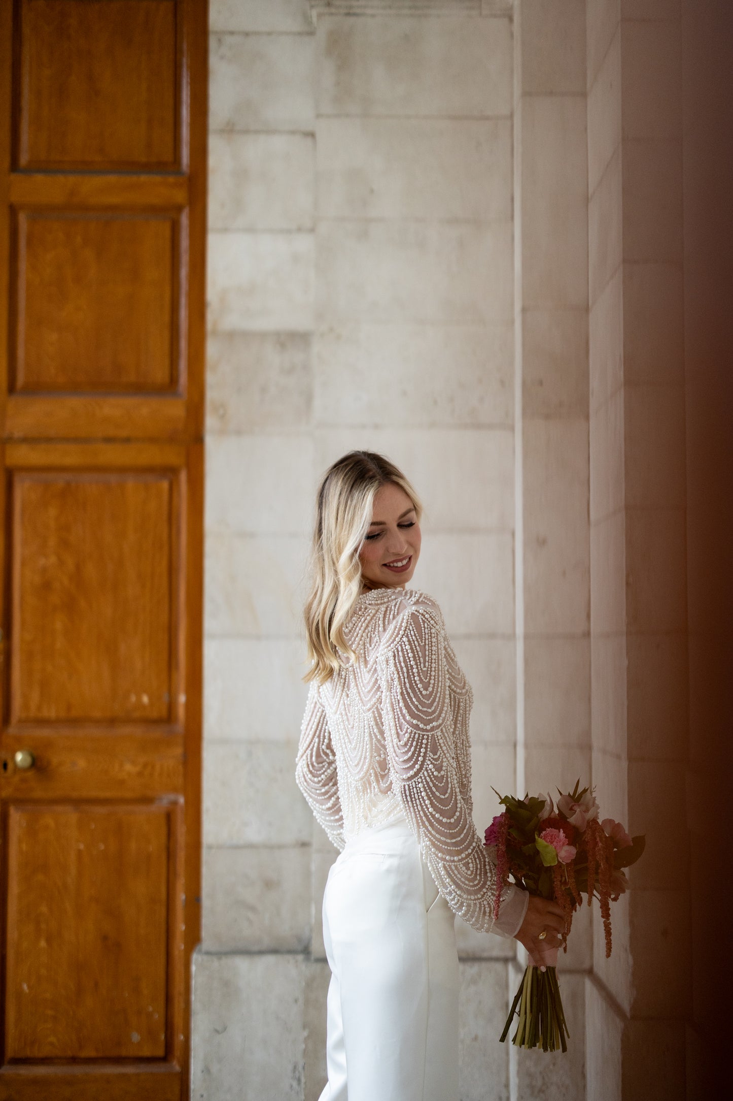 Irish bride wears hand beaded bridal top with sleeves in Cork
