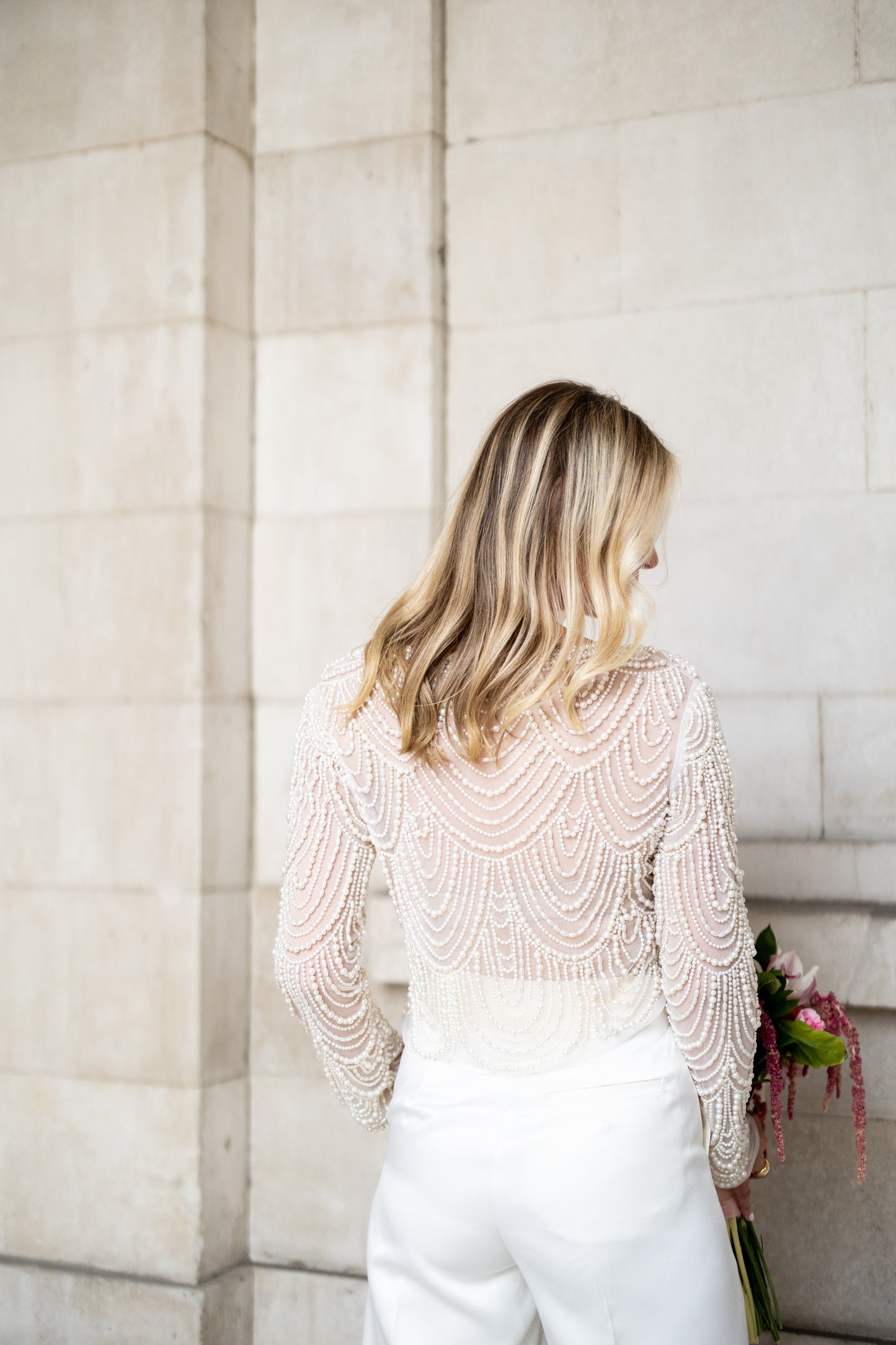 Irish bride wears hand beaded bridal top with sleeves in Cork