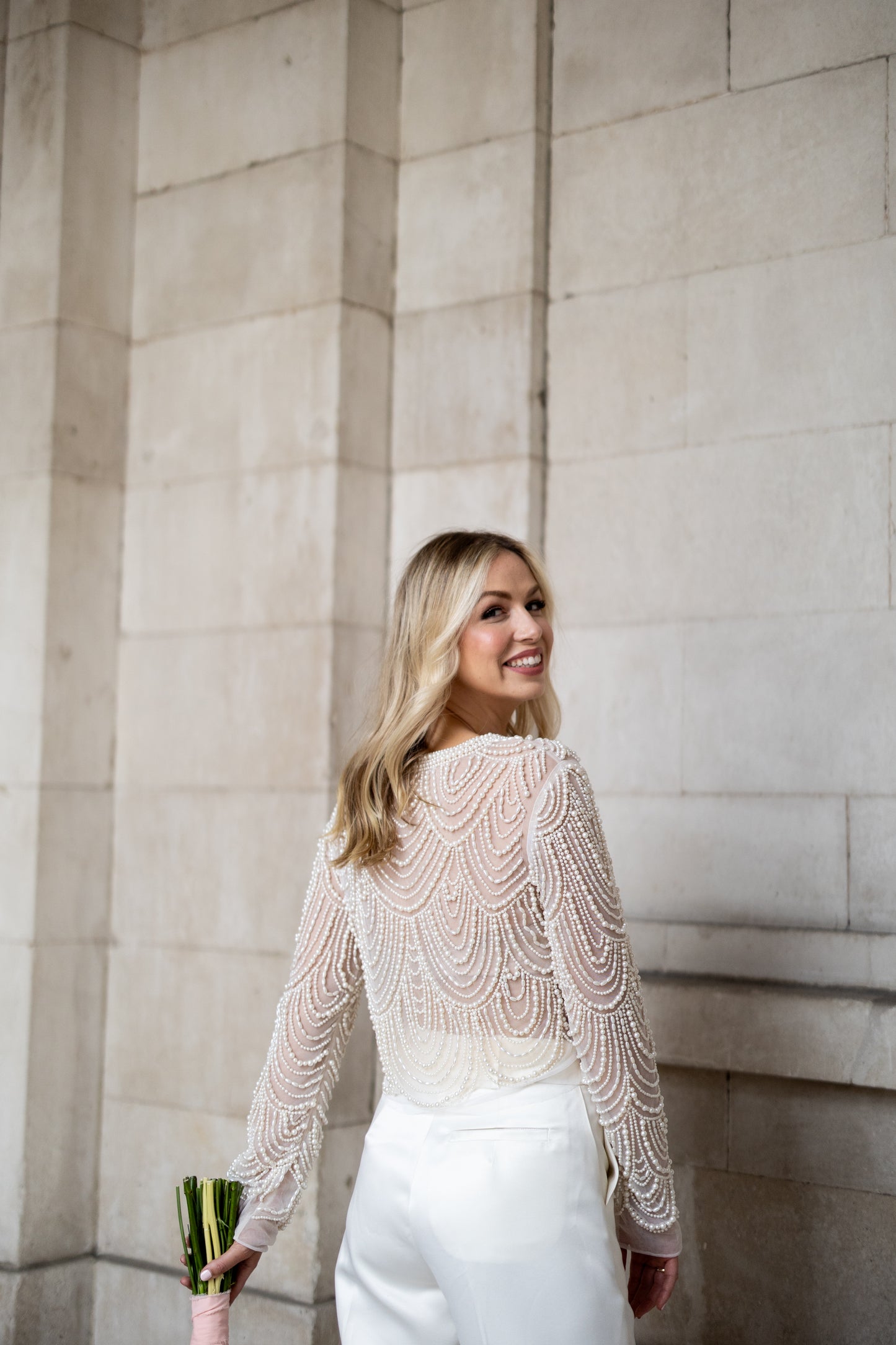 Irish bride wears hand beaded bridal top with sleeves in Cork