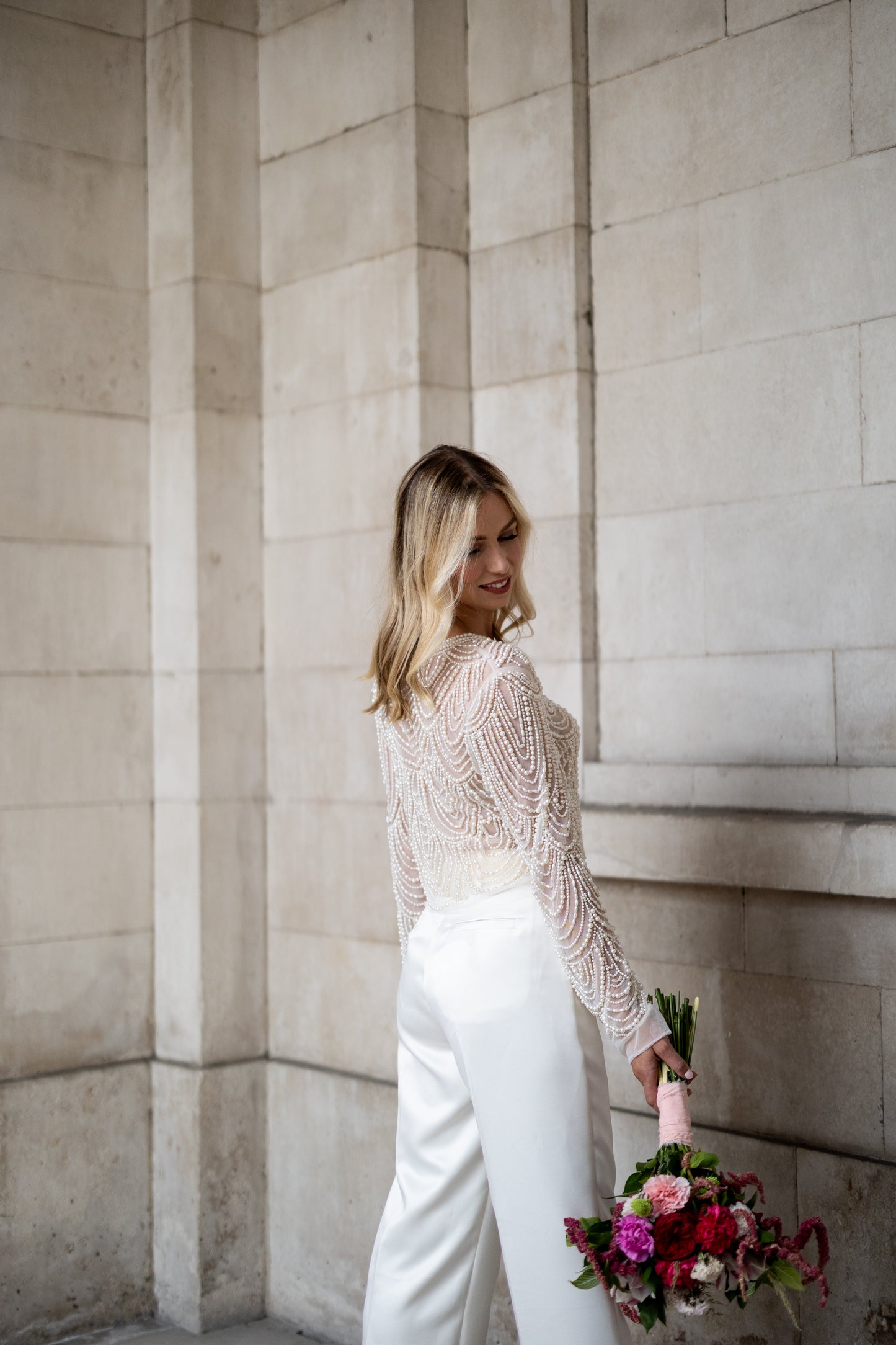 Irish bride wears hand beaded bridal top with sleeves in Cork