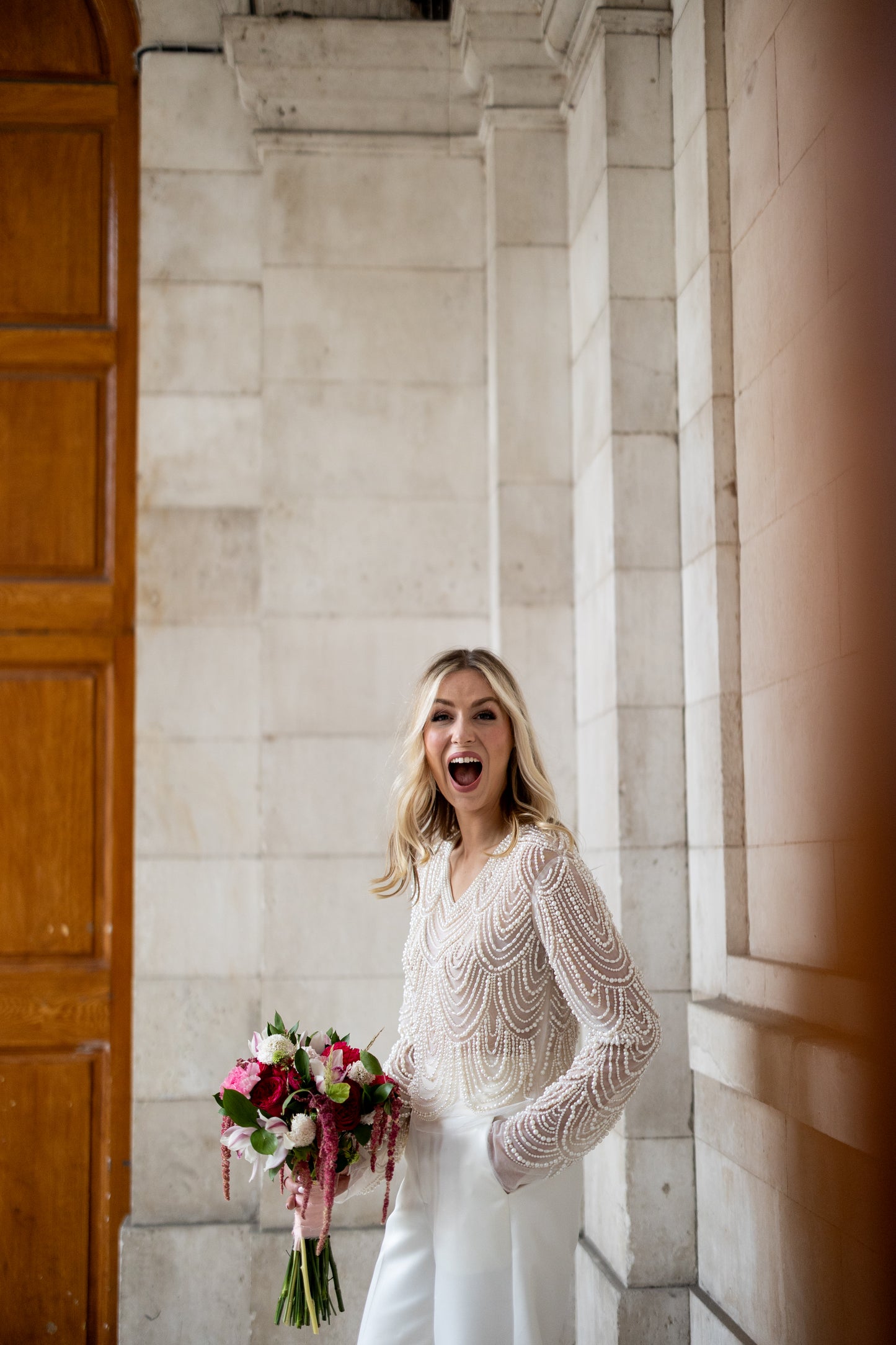 Irish bride wears hand beaded bridal top with sleeves in Cork