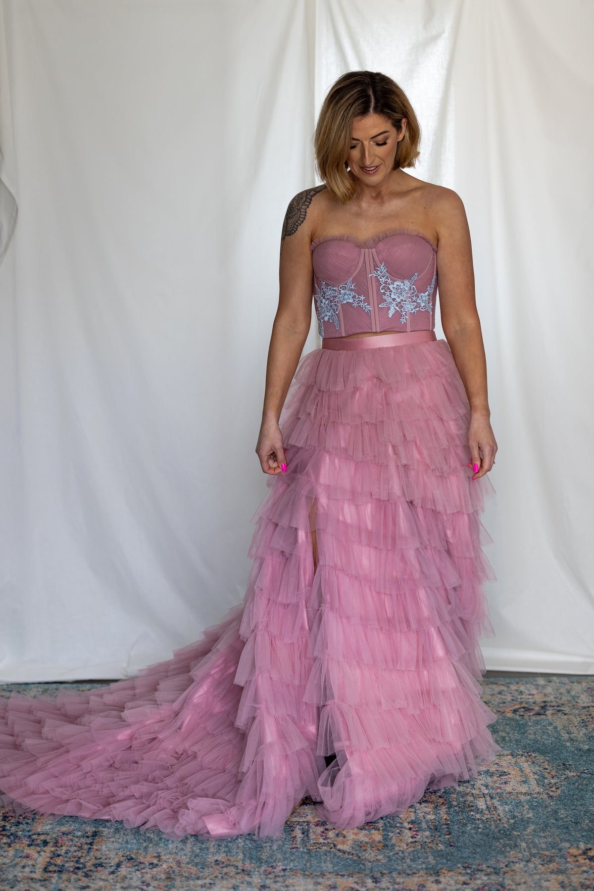 Full-length view of the Carrie Co-ord pink ruffle skirt with train and blue lace corset top – Mizz Rio coloured wedding outfit