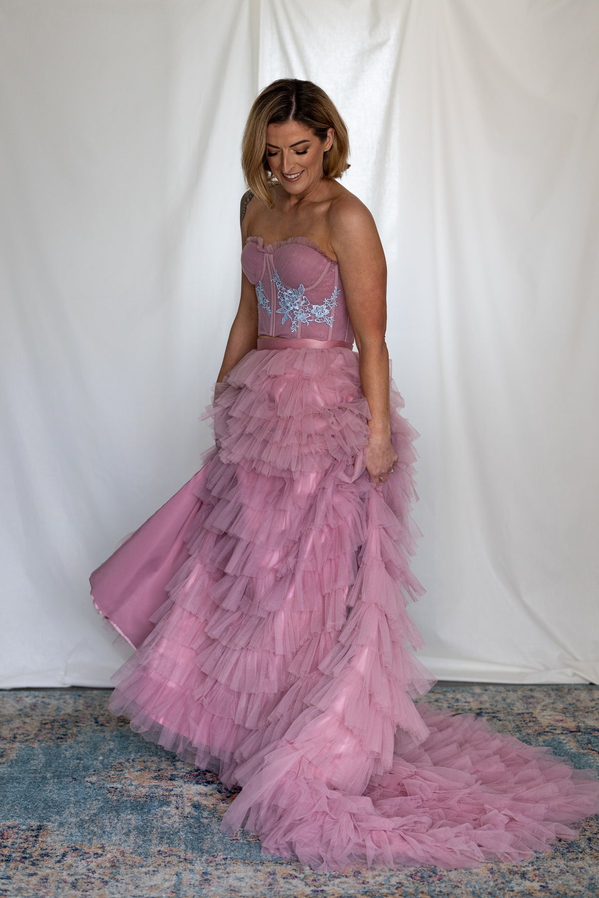 Bride walking in the Carrie Co-ord, its pink ruffle skirt and train in motion – Mizz Rio colourful wedding look