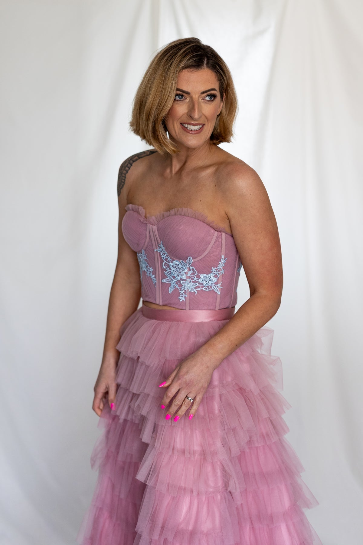 Smiling bride in the Carrie Co-ord blue lace corset top and dusty pink ruffle skirt – Mizz Rio