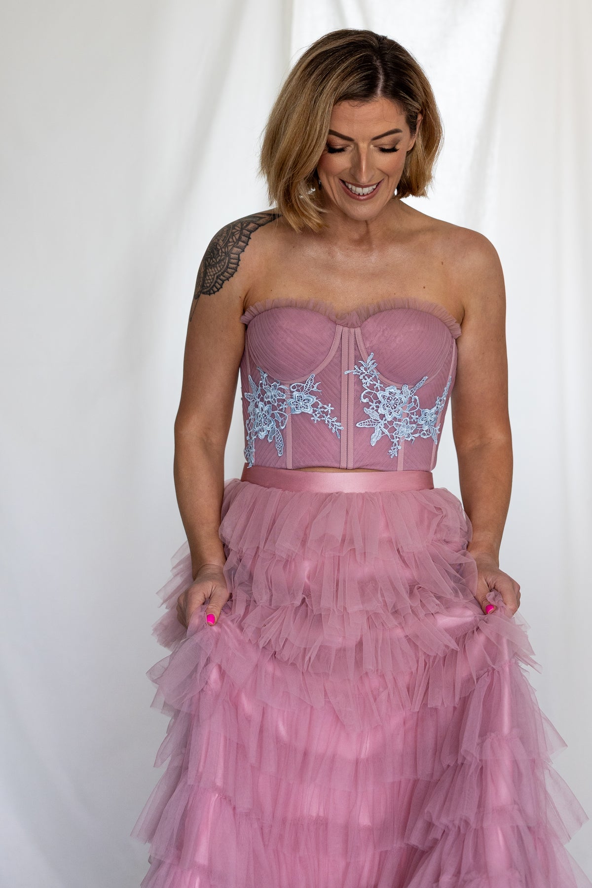 Bride holding the Carrie Co-ord's pink tulle ruffle skirt, with the blue lace corset above – Mizz Rio