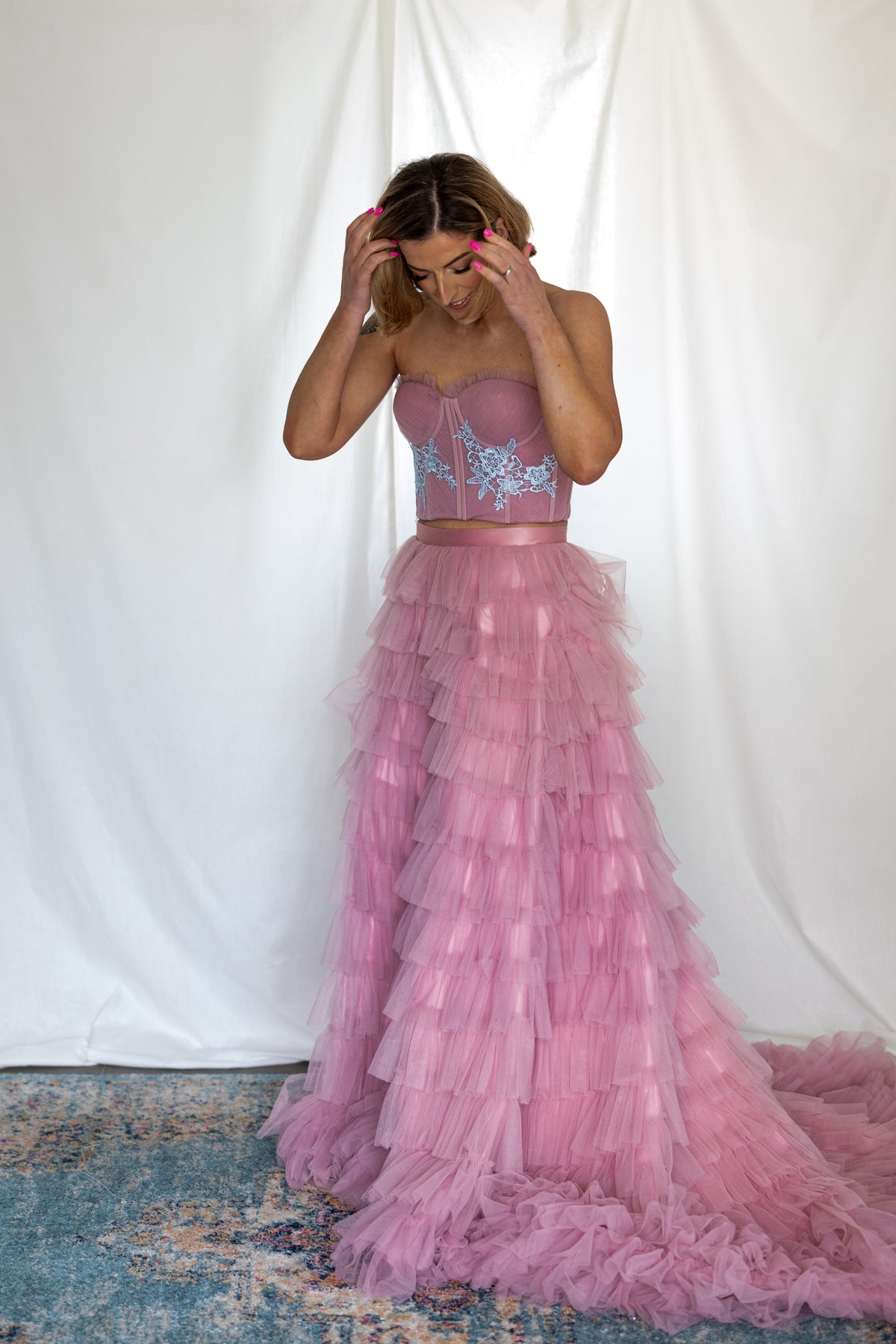 Full-length view of the Carrie Co-ord dusty pink two-piece with its ruffled train – Mizz Rio alternative bridal