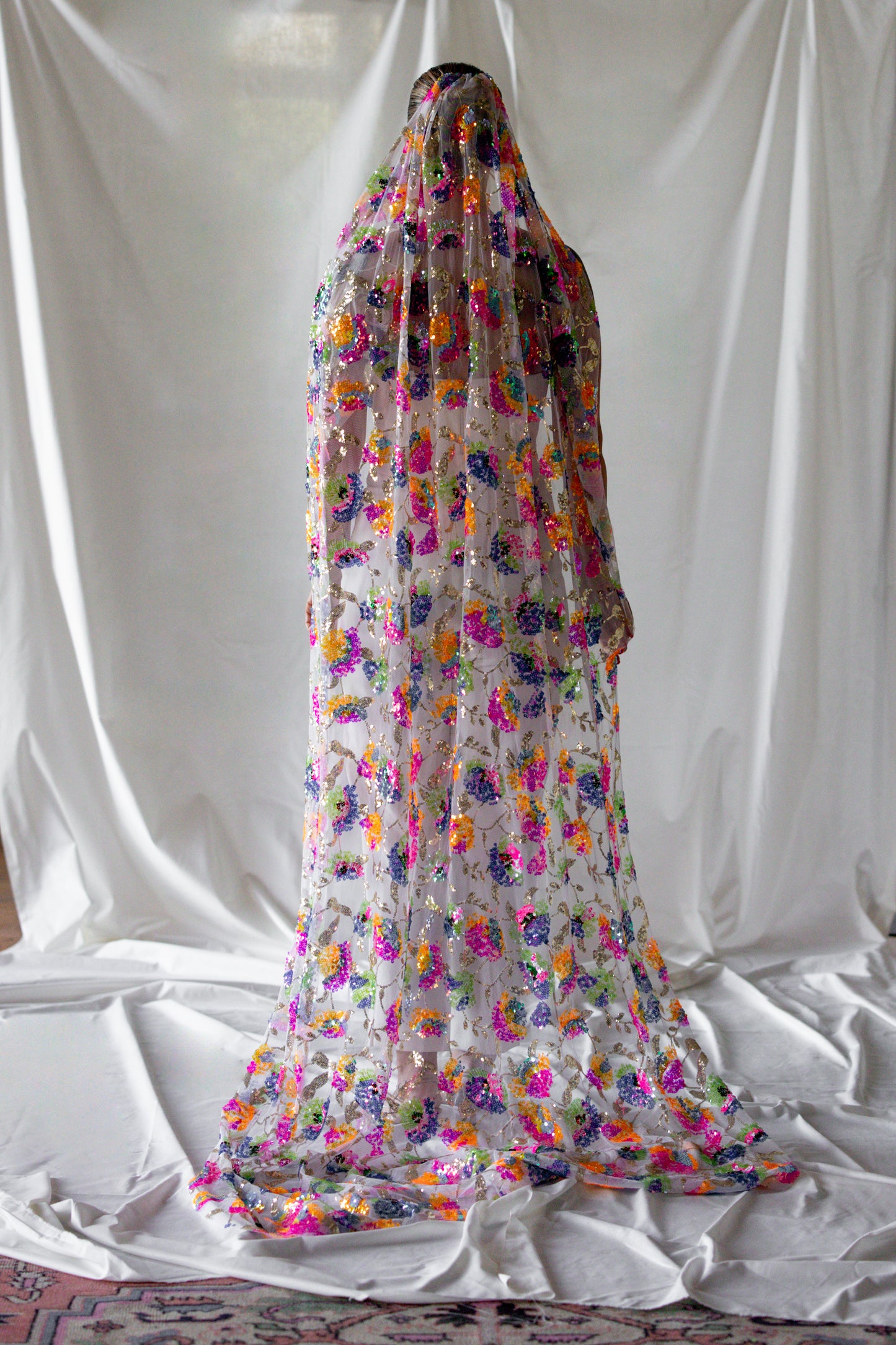 Bride covered in full-length rainbow sequin floral tulle veil and cape by Mizz Rio, colourful alternative bridal accessory in Dublin