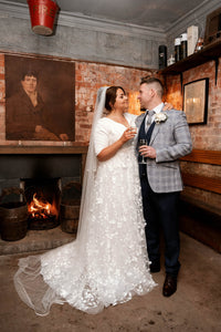 Irish bride wears crepe sleeved wedding dress with 3d lace over skirt in Ireland 