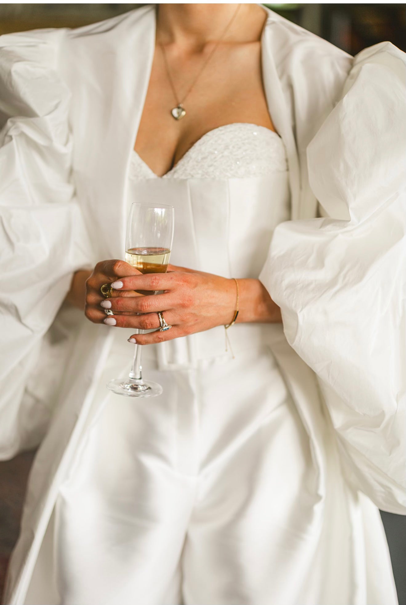 Mizz Rio bride wearing a structured corset wedding dress with an oversized puff-sleeve overtop