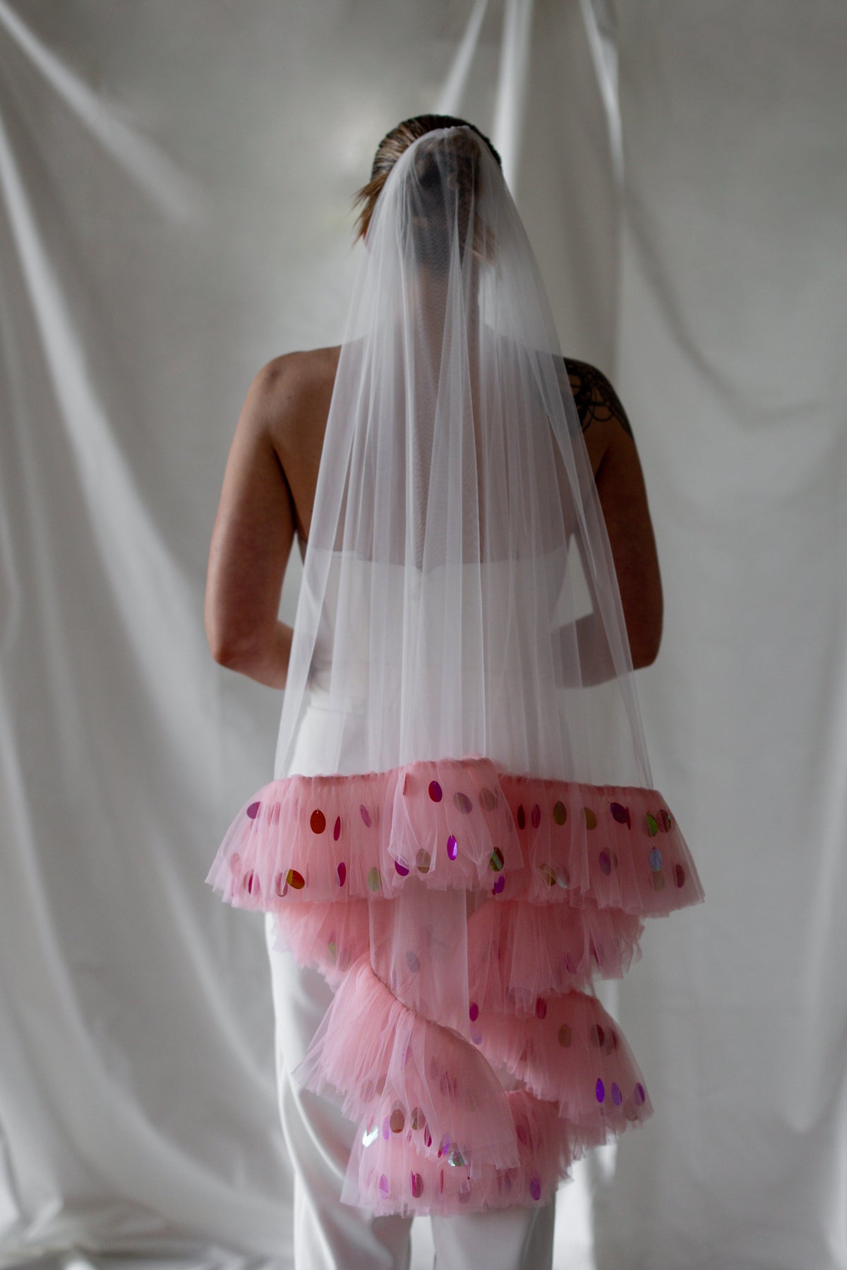 Mizz Rio bride wearing the Cupid’s Bow veil with pink tulle ruffles and colourful sequins