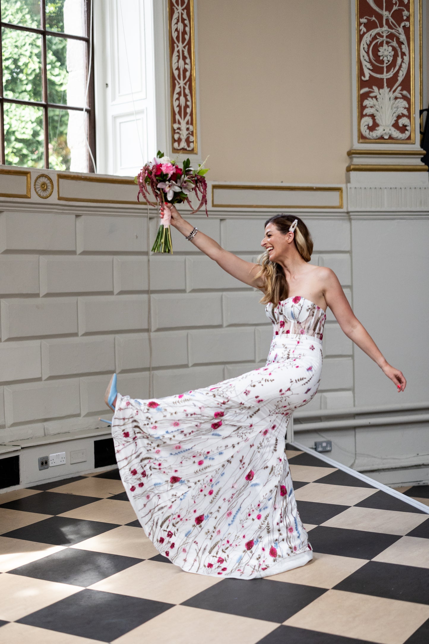 Irish bride wearing a floral wedding dress with pink and blue flowers in Ireland.