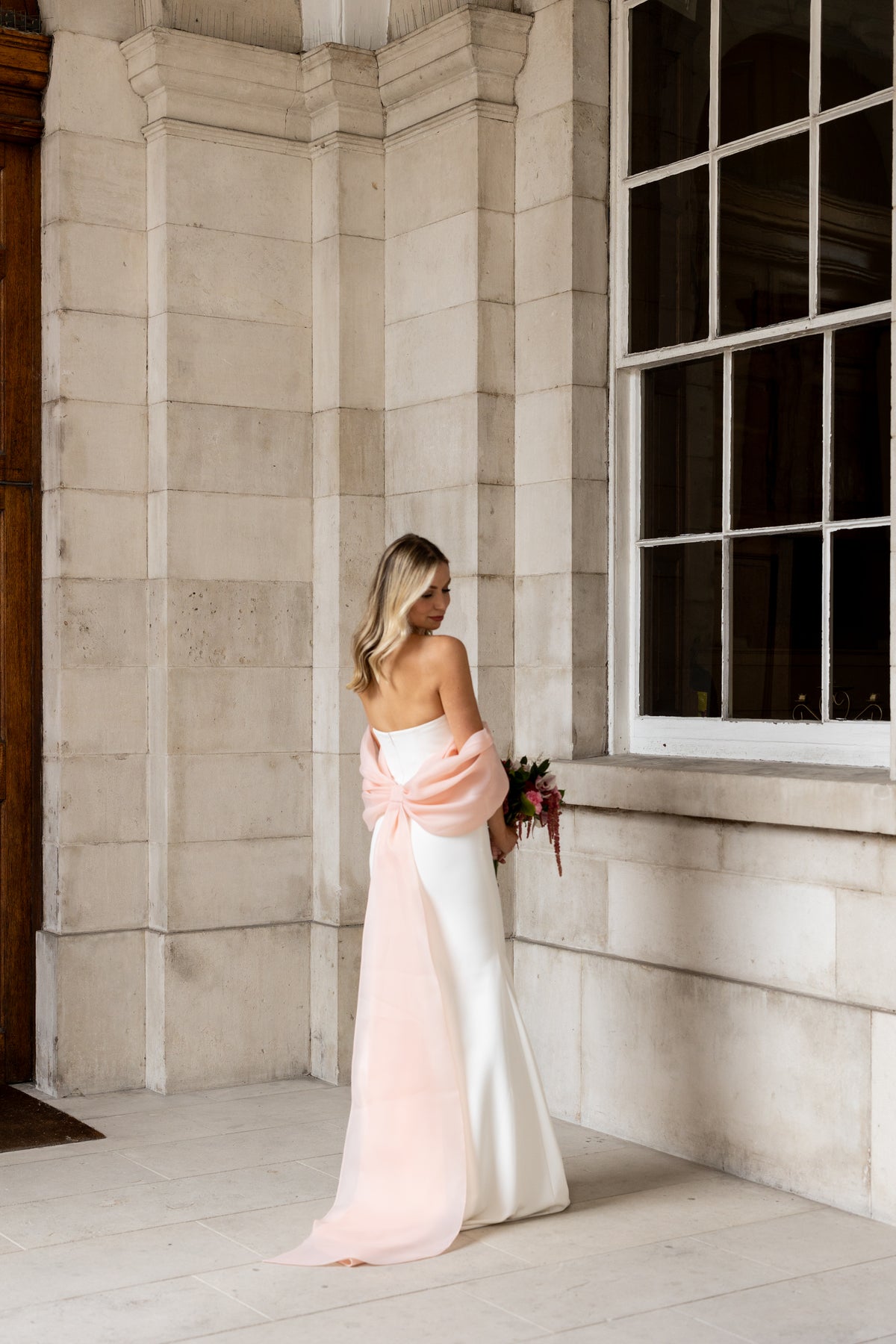 Irish bride wearing a wedding dress and statement pink bow in Dublin. 