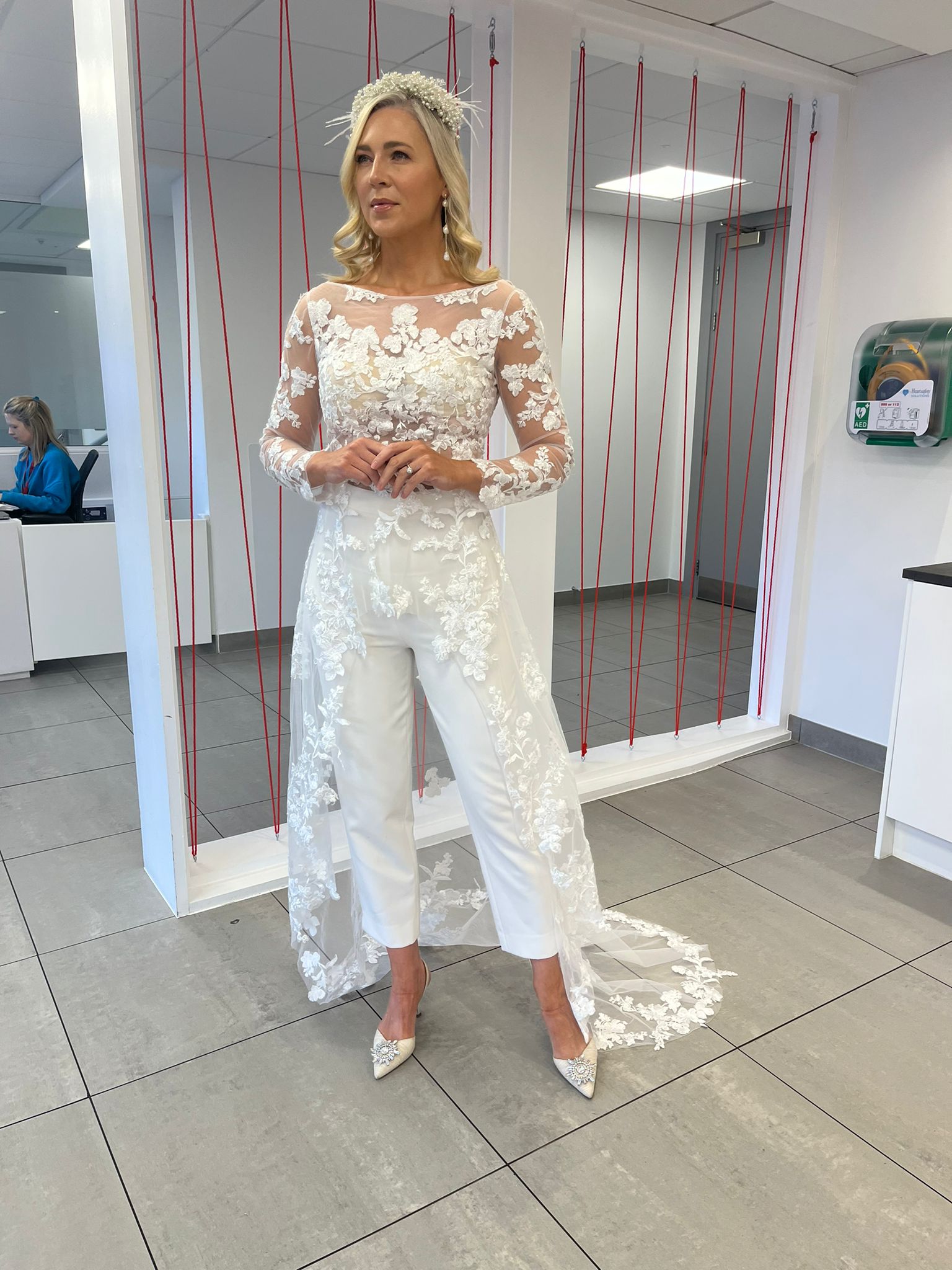 A bride in ireland wearing a bridal jumpsuit with a lace wedding top and bridal trousers