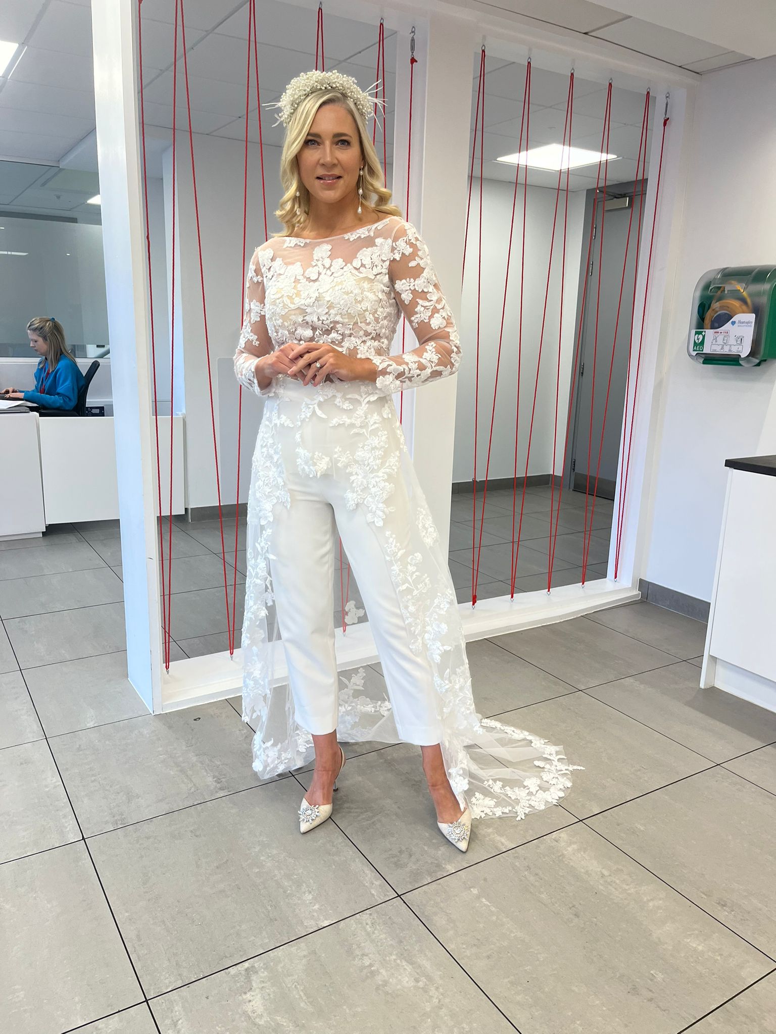 A bride in ireland wearing a bridal jumpsuit with a lace wedding top and bridal trousers