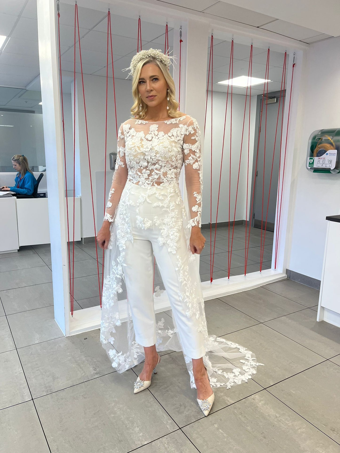 A bride in ireland wearing a bridal jumpsuit with a lace wedding top and bridal trousers