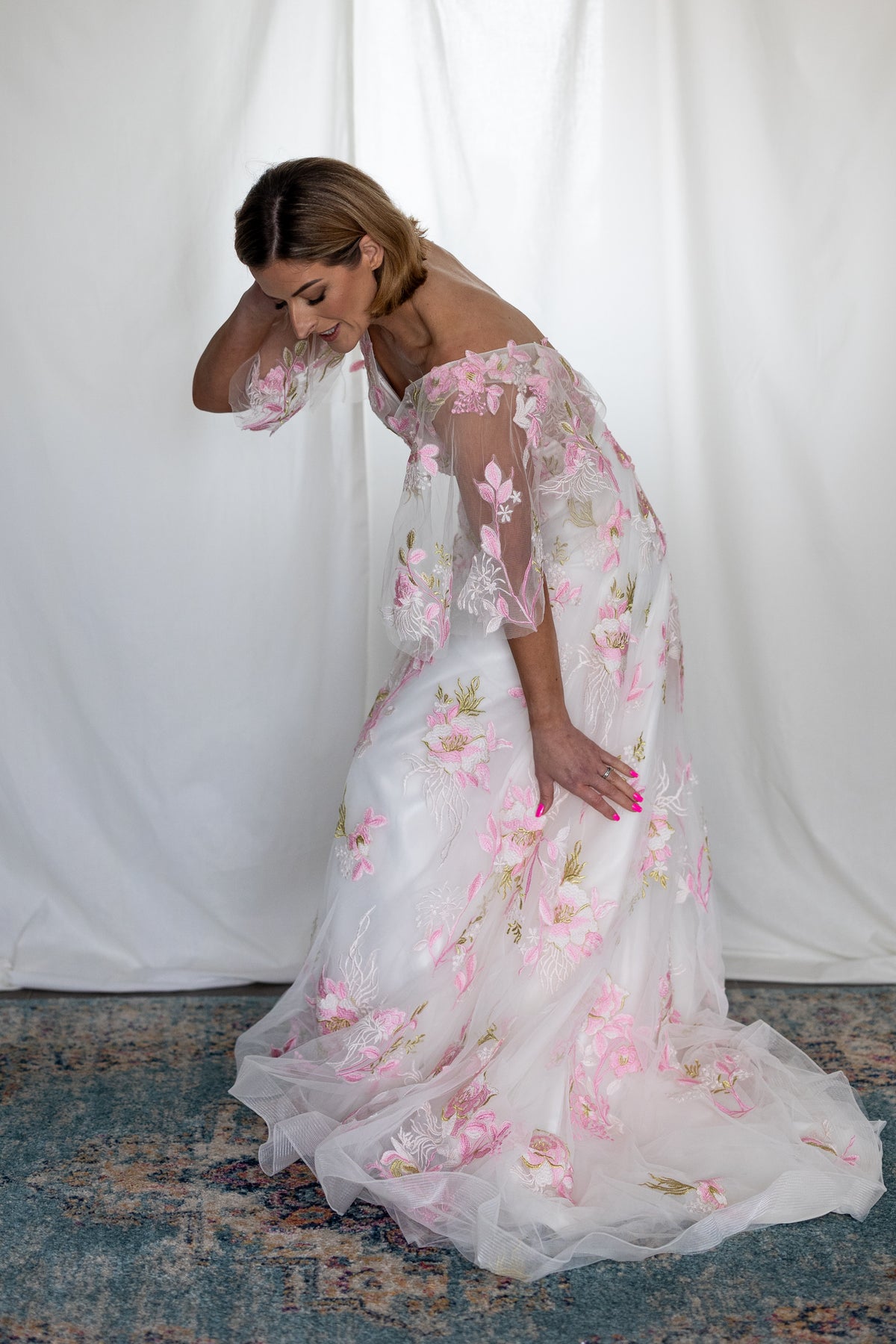 Pink floral embroidered wedding dress with sheer flutter sleeves and layered tulle skirt — modern romantic alternative bridal gown by Mizz Rio in Ireland 