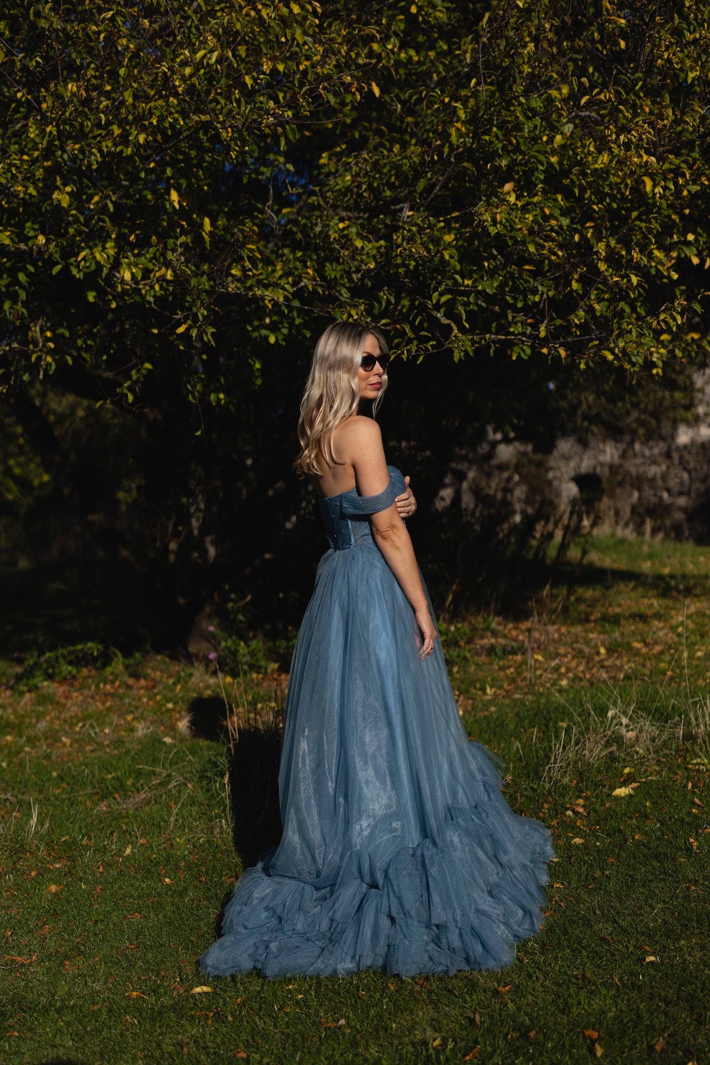 Blue off-the-shoulder tulle wedding dress  with textured ruffled train ireland — editorial outdoor bridal portrait by Mizz Rio