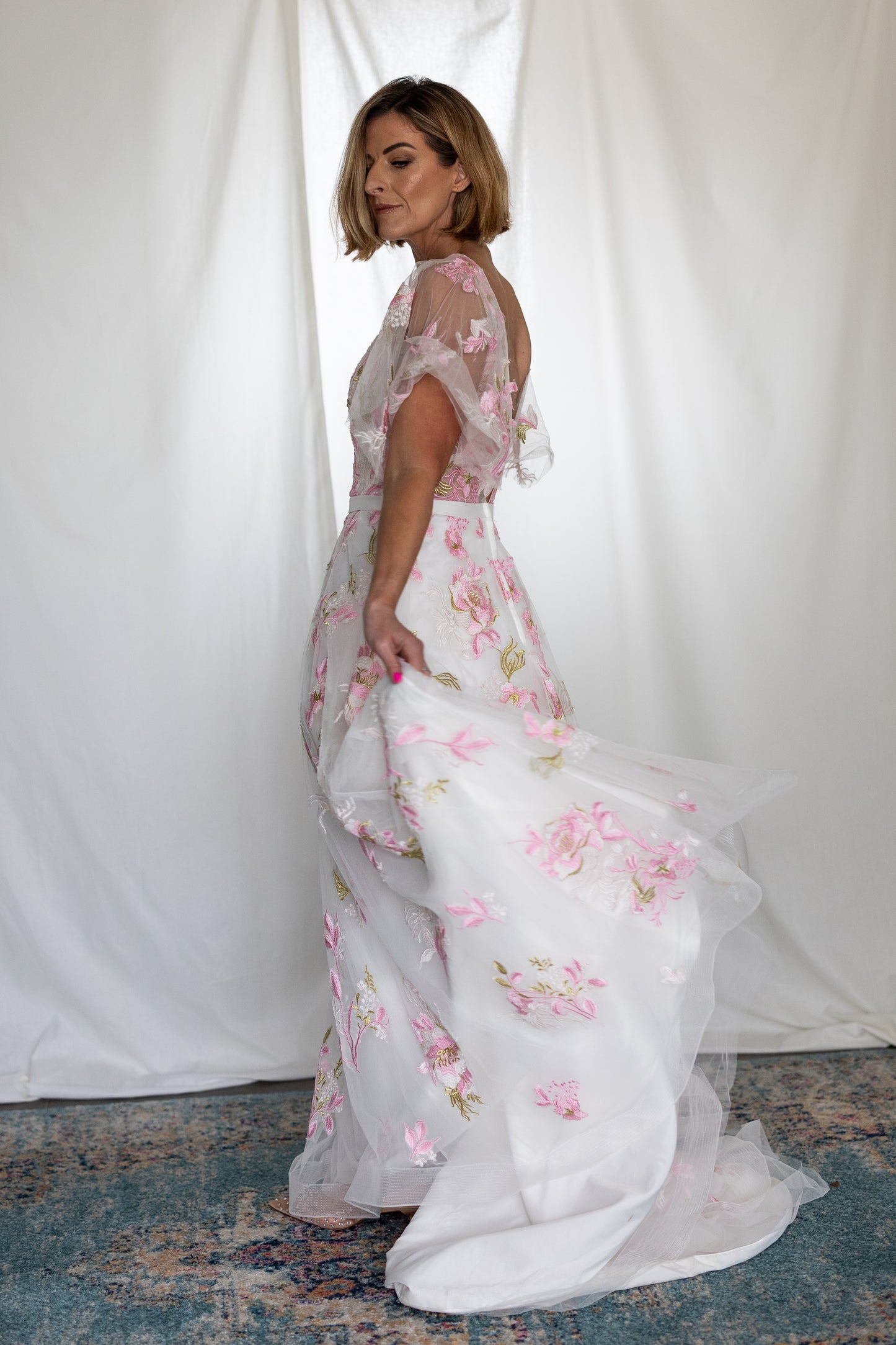 Pink floral embroidered wedding dress with sheer flutter sleeves and layered tulle skirt — modern romantic alternative bridal gown by Mizz Rio in Ireland 