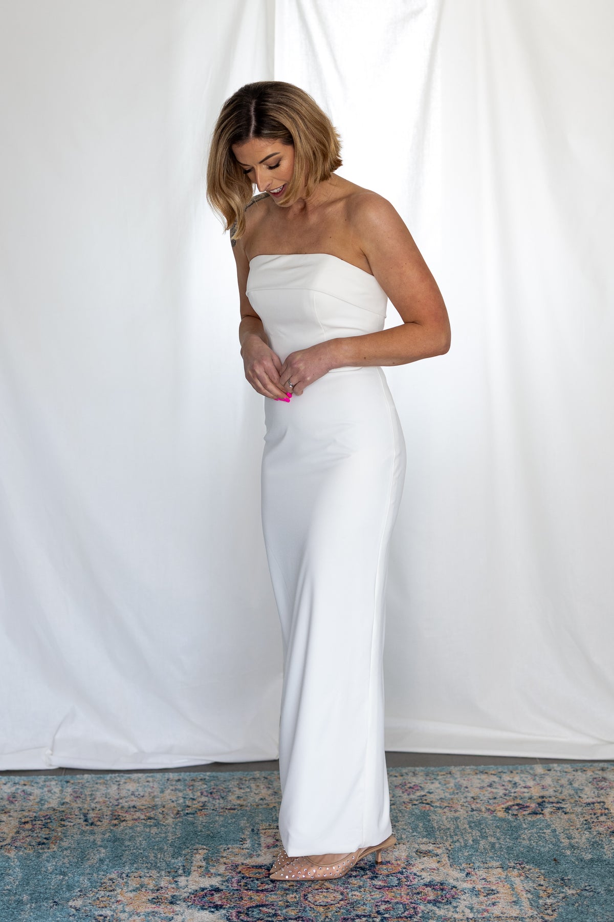 Minimalist strapless column wedding dress with clean satin lines, photographed on bride in studio — modern alternative bridal look by Mizz Rio in Ireland