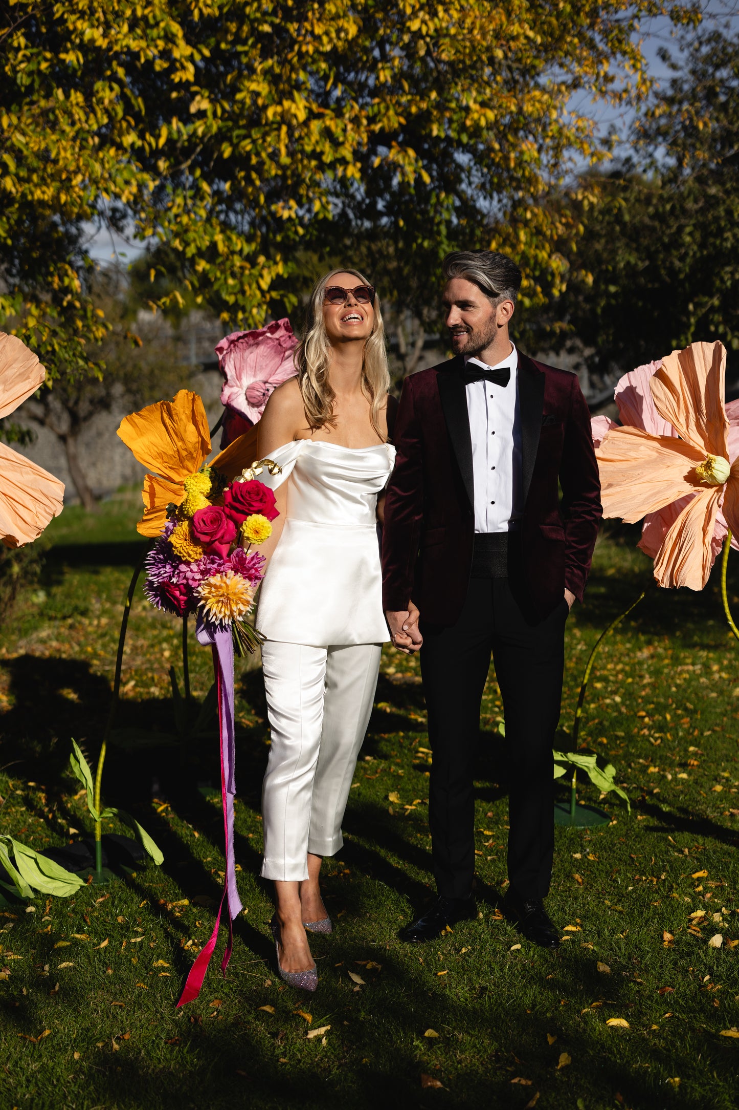 Modern satin bridal jumpsuit with draped bodice and tailored trousers – contemporary alternative wedding look by Mizz Rio