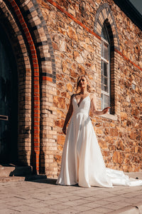Irish bride in minimal wedding dress with pockets walking in Dublin 
