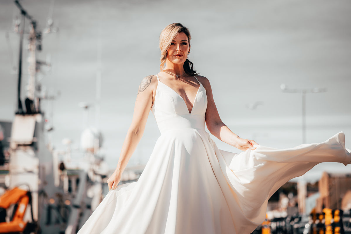 Irish bride in minimal wedding dress with pockets walking in Dublin 
