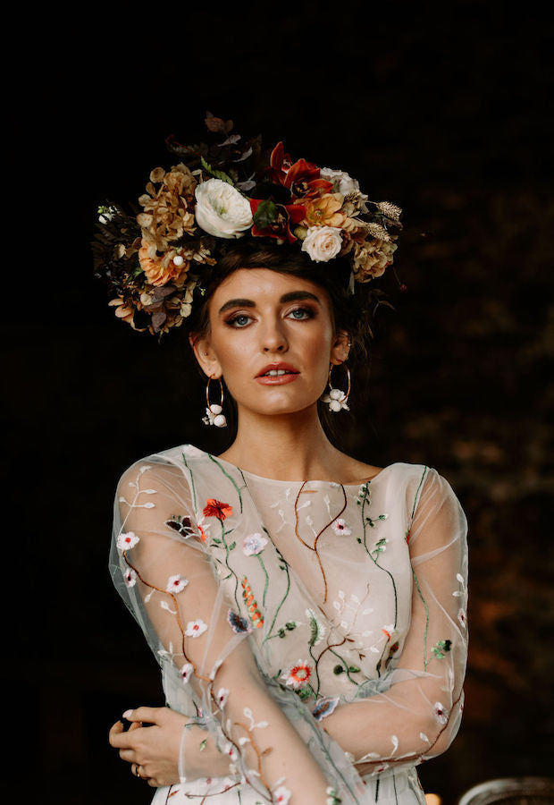 Irish bride wearing a floral wedding dress with sleeves in Ireland.
