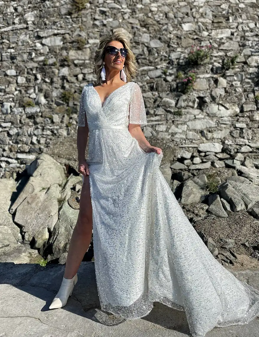 Irish bride wears a sequin ivory wedding dress with high slit and loose sleeves in Ireland 
