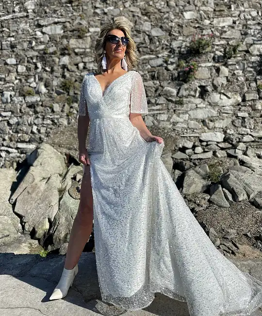 Irish bride wears a sequin ivory wedding dress with high slit and loose sleeves in Ireland 
