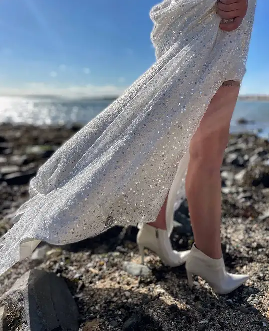 Irish bride wears a sequin ivory wedding dress with high slit and loose sleeves in Ireland 