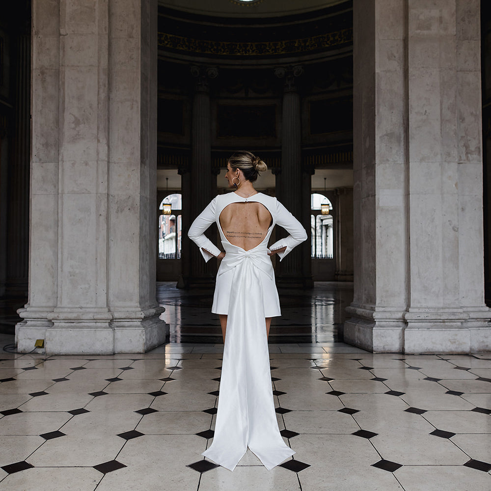 Irish Bride wears a short wedding dress with LONG SLEEVES AND STATEMENT BOW IN cORK 