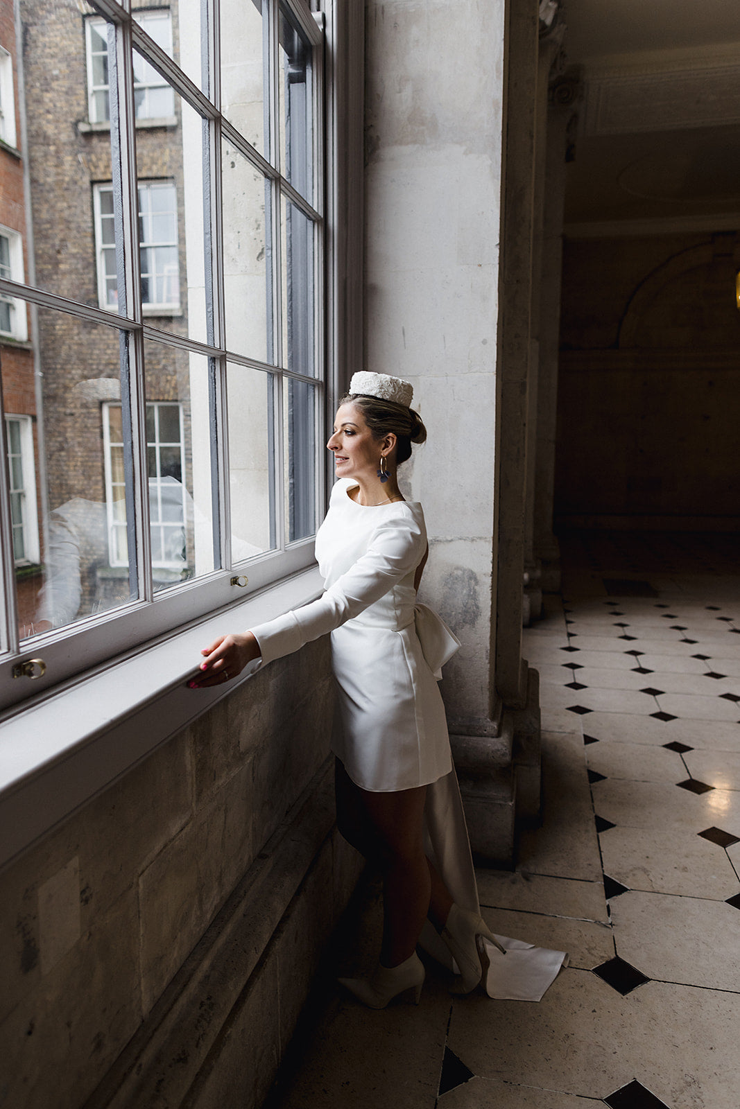 Irish Bride wears a short wedding dress with LONG SLEEVES AND STATEMENT BOW IN cORK 